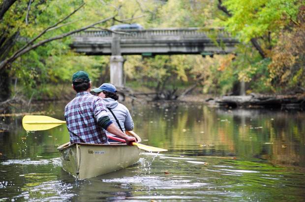 Dave Poulson and Katie Coleman, then a Knight Center student, paddle on the Red Cedar River