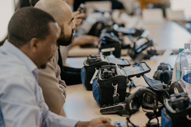 Workshop participants operate audio recording devices